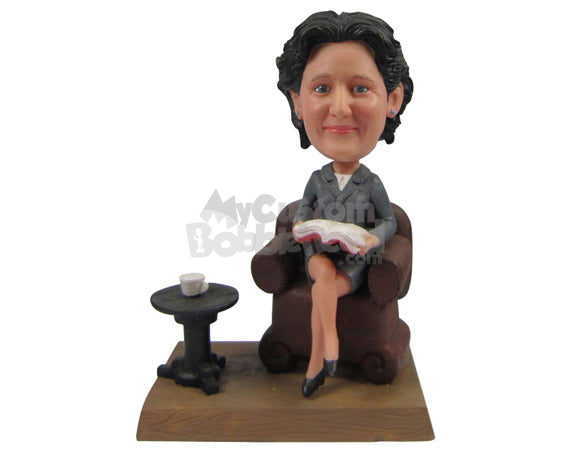 Custom Bobblehead Lady Wearing Jacket Sitting On A Couch Reading A Book And Having A Cup Of Tea - Careers & Professionals Teachers Personalized Bobblehead & Cake Topper Custom Bobblehead Lady Wearing Jacket Sitting On A Couch Reading A Book And Having A Cup Of Tea - Careers & Professionals Teachers Personalized Bobblehead & Cake Topper